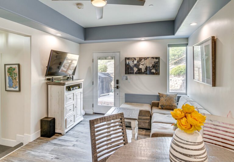 Open concept living area with grey sectional sofa and hardwood floors in Thousand Oaks short term rental