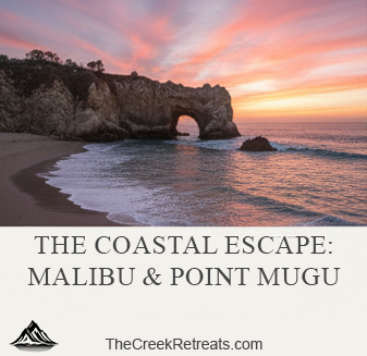 A vibrant pink and orange sunset over the Malibu coastline featuring a natural rock arch in the ocean.