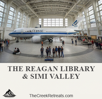 The interior of a large hangar at the Reagan Library displaying a full-sized presidential Air Force One airplane.